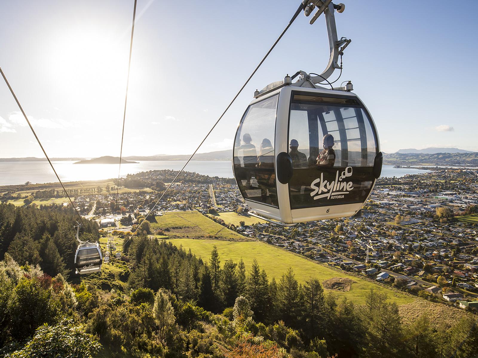 The Rotorua gondola in the air heading towards a sunset