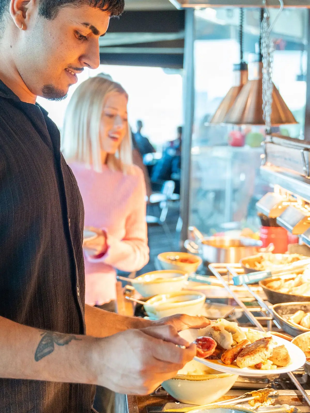 Guests serving themselves at a buffet dining experience at Skyline Rotorua Stratosfare Restaurant
