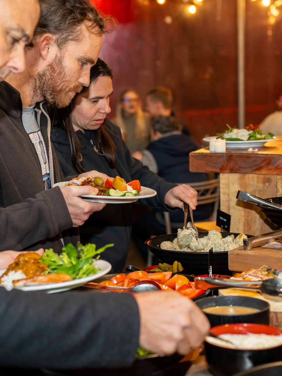 Guests serving themselves at a buffet dining experience at Skyline Rotorua Stratosfare Restaurant