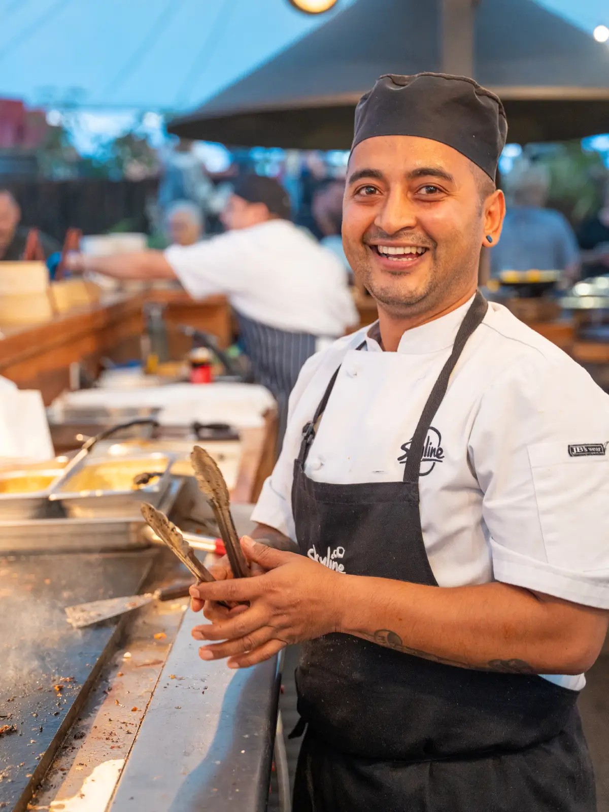 Chef preparing food at the Hidden Forest event venue at Skyline Rotorua