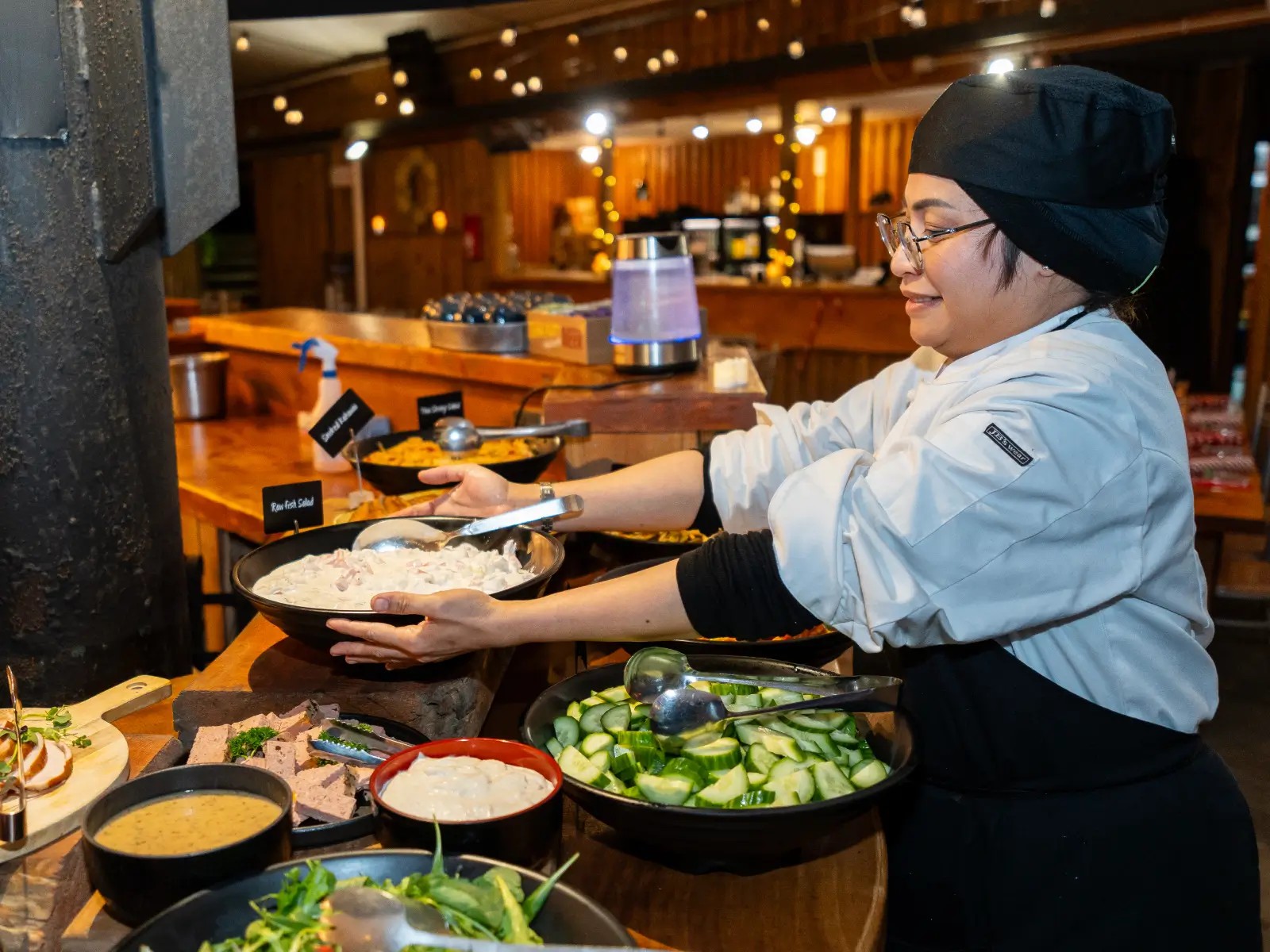 Chef preparing buffet dishes for a Christmas function at Skyline Rotorua
