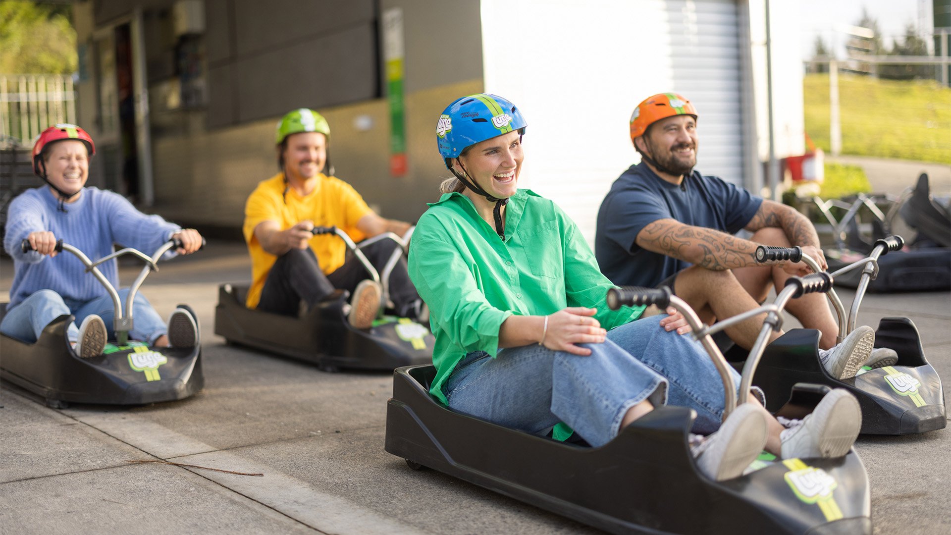 Friends sitting in the Luge cart ready to take off down the track