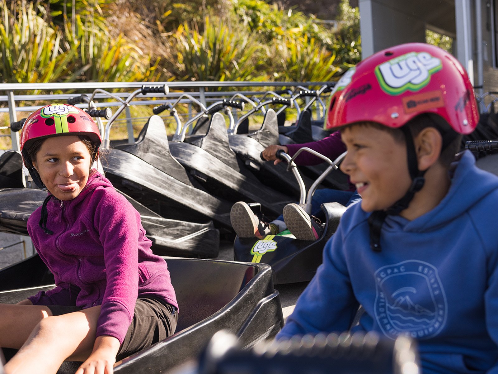 Two young kids at the end of the Luge track